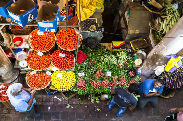 People shops for fresh fruits and vegetables in the traditional fresh market of Port Louis