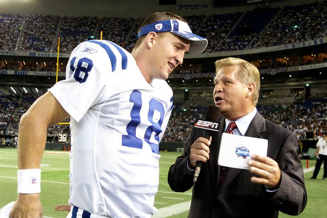 <p>A. Messerschmidt/Getty</p> Peyton Manning talks with ESPN sideline reporter Chris Mortensen in 2005
