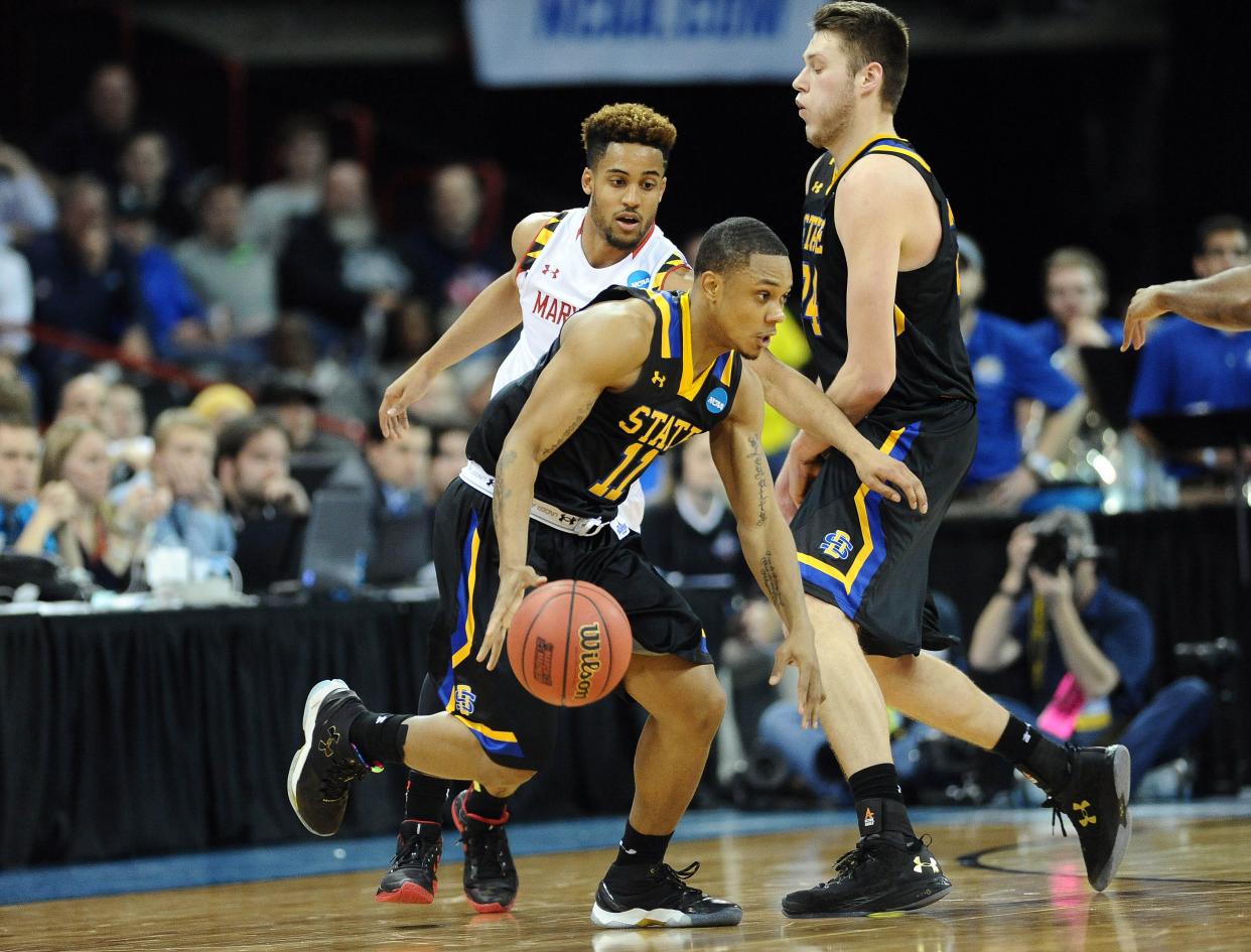 South Dakota State Jackrabbits guard George Marshall (11) moves the ball as forward Mike Daum (24) provides the screen against Maryland Terrapins guard Melo Trimble (2) during the second half at Spokane Veterans Memorial Arena.