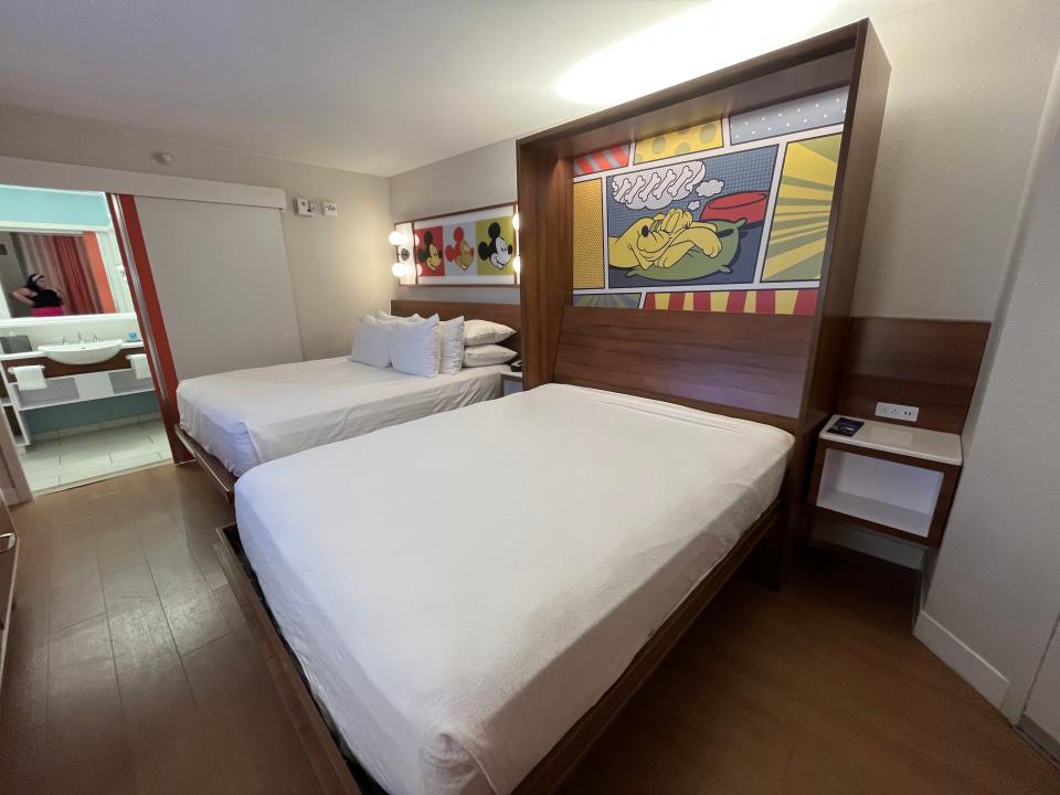 queen bed and murphy bed set up in a standard room at pop century resort in disney world