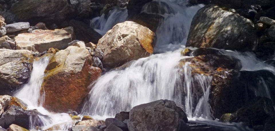 This Monday, June 10, 2019, photo shows mountain runoff, in the Big Cottonwood canyon, near Salt Lake City. The summer's melting snowpack is creating raging rivers that are running high, fast and icy cold. The state's snowpack this winter was about 150 percent higher than the historical average and double the previous year, which was the driest on record dating back to 1874, said Brian McInerney, hydrologist for the National Weather Service in Salt Lake City. (AP Photo/Rick Bowmer)