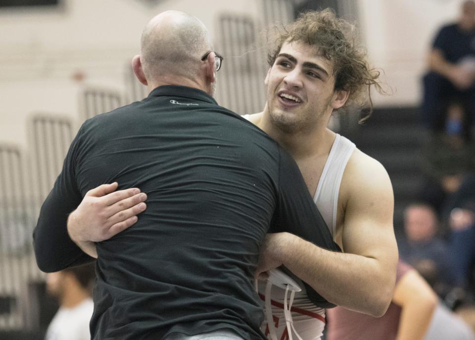 Delsea's Danny DiGiovacchino celebrates with Delsea's assistant wrestling coach George Maxwell after DiGiovacchino pinned Middle Twp.'s David Giulian to win the 190-pound final of the Region 8 wrestling championships at Egg Harbor Township High School, Saturday, Feb. 26, 2022.