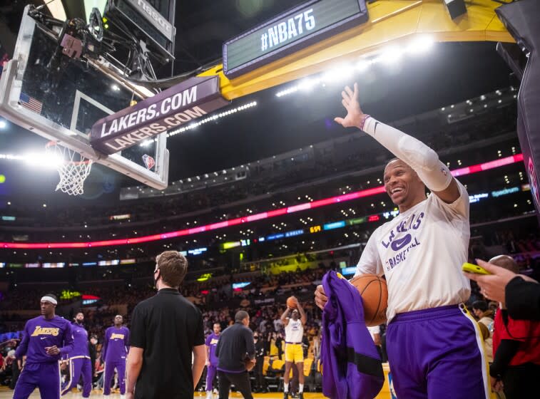 Los Angeles, CA - October 19: New Los Angeles Lakers guard Russell Westbrook waves with excitement as he plays his first season game with the Lakers before the start of the season opener with the Golden State Warriors at the Staples Center in Los Angeles, CA on Tuesday, Oct. 19, 2021. (Allen J. Schaben / Los Angeles Times).