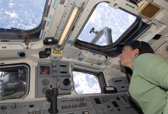 Megan McArthur looks out the shuttle Atlantis' aft cockpit windows at the Hubble Space Telescope during a final servicing mission in 2009. / Credit: NASA