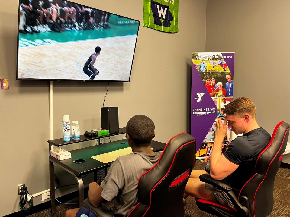 Barry Adoobe, left, and Nick Boergen play an NBA 2K game on one of the Xbox Series X consoles in the John Grubb YMCA's refinished Teen Center, Thursday, June 23, 2022, in Des Moines.