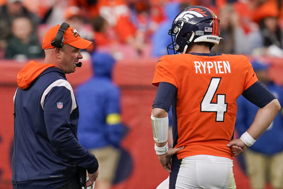 Denver Broncos head coach Nathaniel Hackett speaks to Denver Broncos quarterback Brett Rypien (4) during the second half of an NFL football game against the New York Jets, Sunday, Oct. 23, 2022, in Denver. (AP Photo/Matt York)