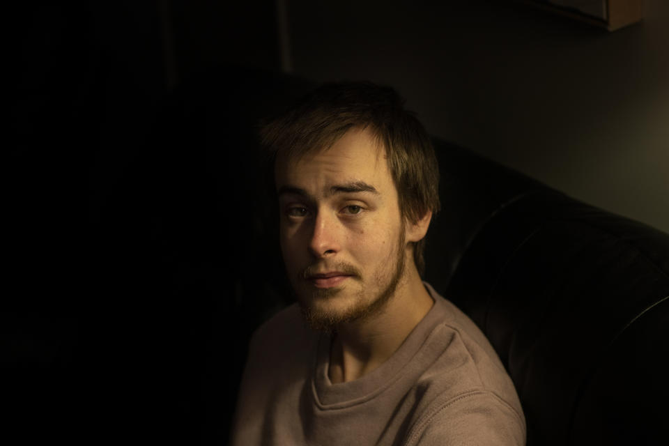 Sam Ware, 22, sits for a photo in his mother's home, in Fountaindale, Central Coast, Australia, Friday, July 19, 2019. The instructions following his wisdom tooth surgery stated that he should take two opioid painkillers for his pain that night. He took four. Sam loved the buzz they'd given him. The codeine had made him feel safe and warm, like being tucked into a cozy bed on a cold winter's night. He wanted more. (AP Photo/David Goldman)