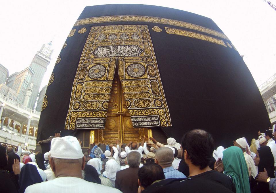 Muslims touch and pray at the door of the Kaaba, as well as touch and kiss the al-Hajr al-Aswad "Black Stone", during their Umrah Mawlid al-Nabawi pilgrimage, at the Grand Mosque in the holy city of Mecca