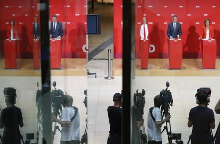 Social Democratic Party leadership team address media after first exit polls at the party's headquarters in Berlin