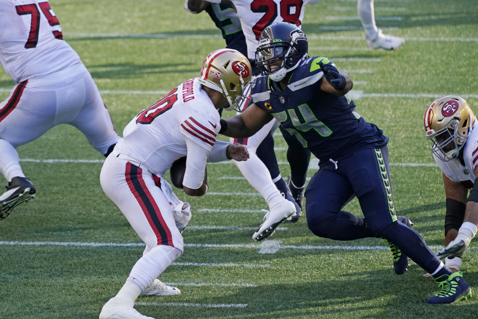 Seattle Seahawks middle linebacker Bobby Wagner, right, sacks San Francisco 49ers quarterback Jimmy Garoppolo during the first half of an NFL football game, Sunday, Nov. 1, 2020, in Seattle. (AP Photo/Elaine Thompson)