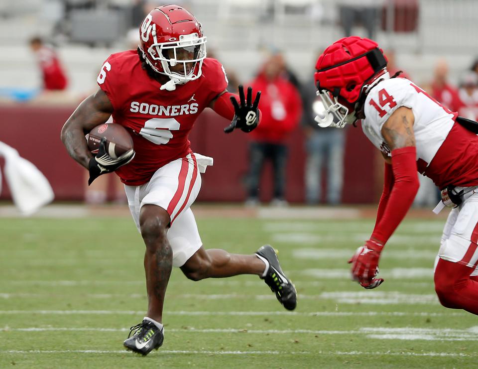 OU's Deion Burks runs past Jaydan Hardy during Saturday's spring game at Gaylord Family-Oklahoma Memorial Stadium in Norman.