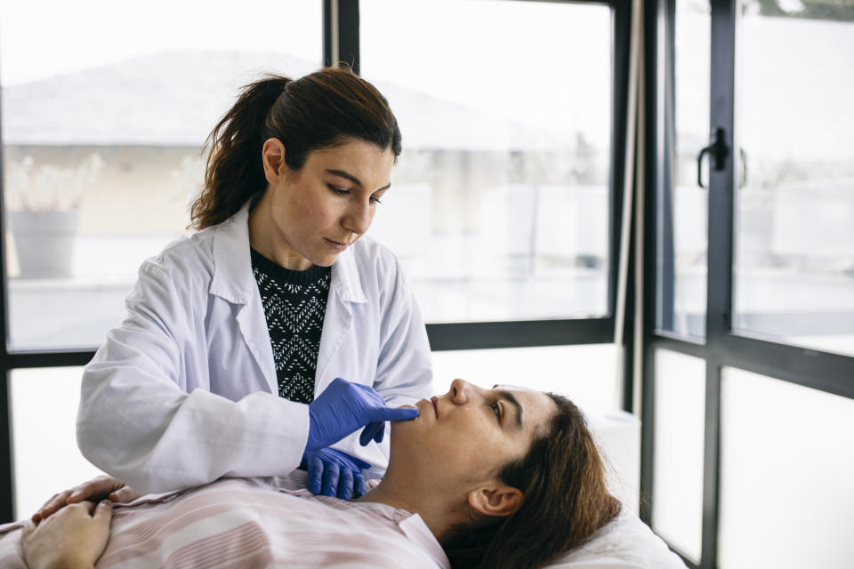 A patient is getting assessed by a doctor