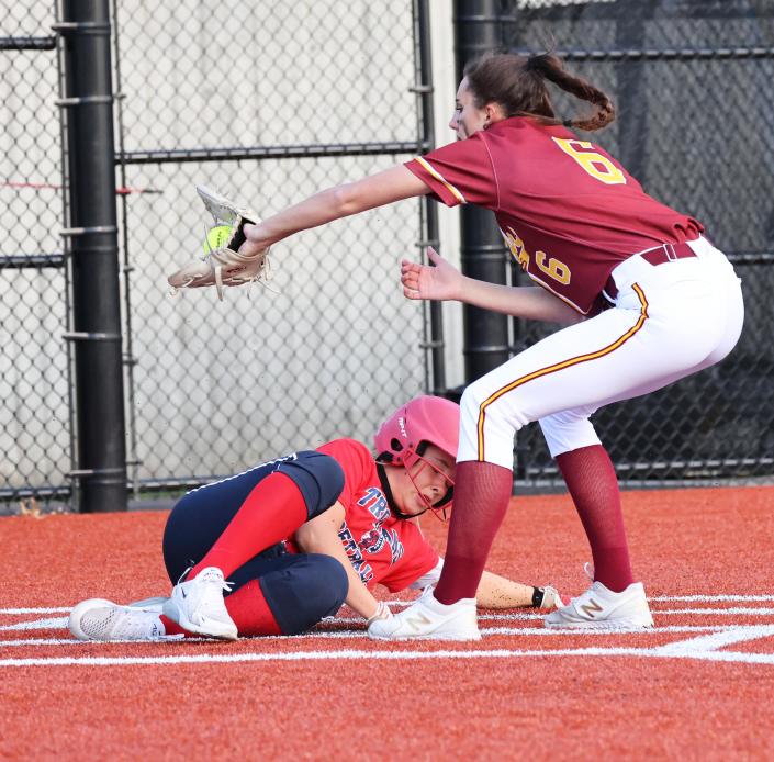 Cardinal Spellman&#39;s Ava Loud waits for throw as Bridgewater-Raynham runner Emma Flaherty slides in safely during a scrimmage game on Friday, April 1, 2022.