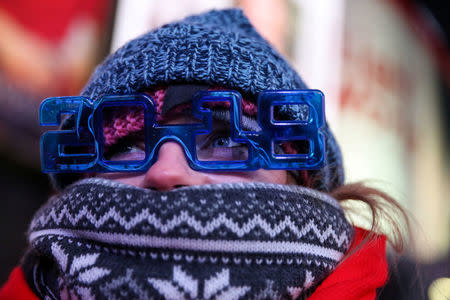 A woman stands in Times Square ahead of the New Year's Eve celebrations in Manhattan, New York, U.S., December 31, 2017. REUTERS/Amr Alfiky