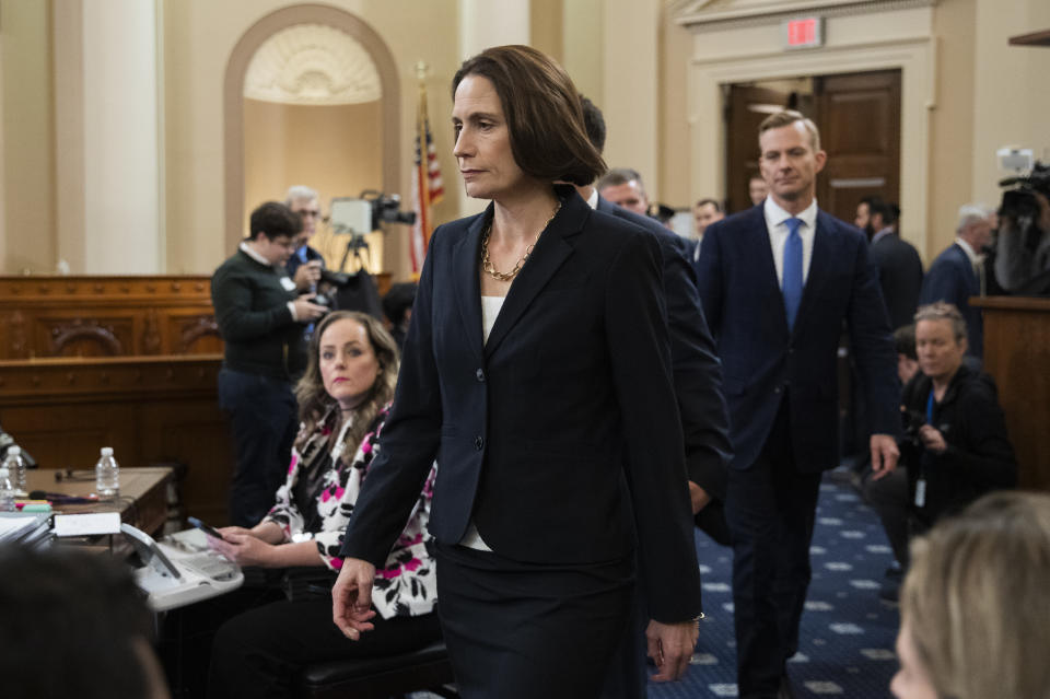 Former White House national security aide Fiona Hill, and David Holmes, a U.S. diplomat in Ukraine, back right, walk to their seats to testify before the House Intelligence Committee on Capitol Hill in Washington, Thursday, Nov. 21, 2019, during a public impeachment hearing of President Donald Trump's efforts to tie U.S. aid for Ukraine to investigations of his political opponents. (AP Photo/Manuel Balce Ceneta)