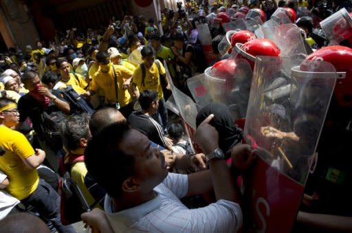 Protestors clash with police during an anti-government rally in Kuala Lumpur on April 28, 2012. Thousands of protesters gathered in the Malaysian capital to demand electoral reform, defying a lockdown of central Kuala Lumpur that left it a maze of razor wire and barricades