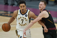 Indiana Pacers' Malcolm Brogdon, left, drives to the basket against Cleveland Cavaliers' Dylan Windler during the second half of an NBA basketball game, Wednesday, March 3, 2021, in Cleveland. (AP Photo/Tony Dejak)