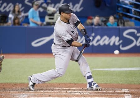 Mar 29, 2018; Toronto, Ontario, CAN; New York Yankees catcher Gary Sanchez (24) hits an RBI double in the fifth inning during the Toronto Blue Jays home opener at Rogers Centre. Mandatory Credit: Nick Turchiaro-USA TODAY Sports