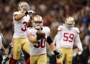 Nov 9, 2014; New Orleans, LA, USA; San Francisco 49ers inside linebacker Chris Borland (50) celebrates after a fumble by New Orleans Saints quarterback Drew Brees (not pictured) in overtime at Mercedes-Benz Superdome. The 49ers won 27-24. Mandatory Credit: Chuck Cook-USA TODAY Sports