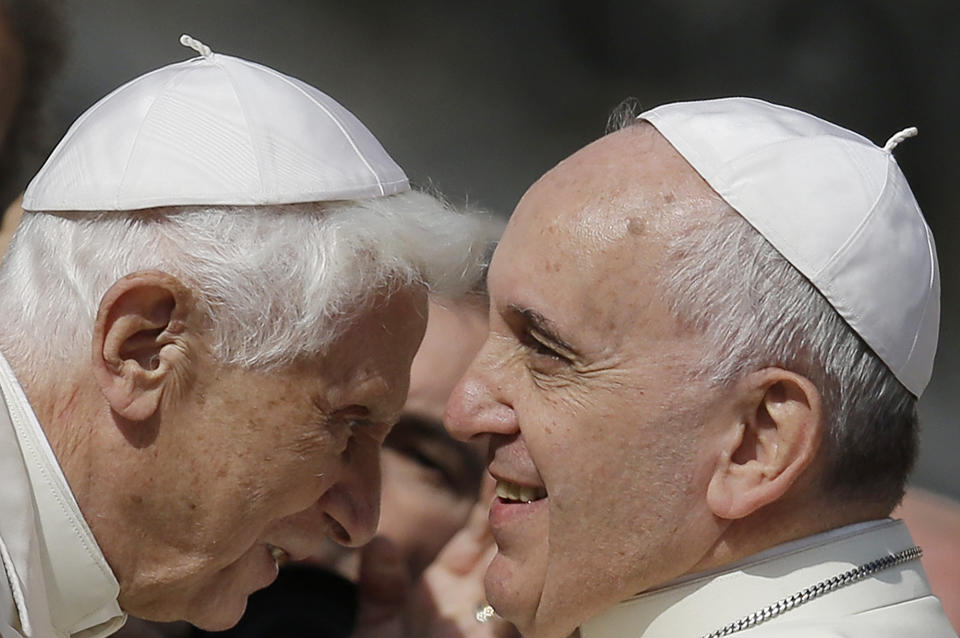 FILE - Pope Francis, right, greets Pope Emeritus Benedict XVI prior to the start of a meeting with elderly faithful in St. Peter's Square at the Vatican, on Sept. 28, 2014. Pope Benedict XVI’s 2013 resignation sparked calls for rules and regulations for future retired popes to avoid the kind of confusion that ensued. Benedict, the German theologian who will be remembered as the first pope in 600 years to resign, has died, the Vatican announced Saturday Dec. 31, 2022. He was 95. (AP Photo/Gregorio Borgia, File)