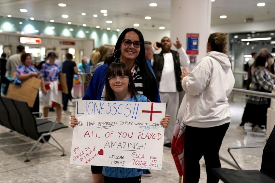 England fans Sian and Minnie, from Coventry, were among those at Heathrow Airport on Tuesday morning (Andrew Matthews) (PA Wire)