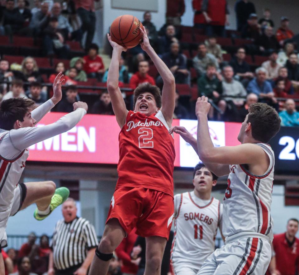 Tommy Lineman of Tappan Zee splits Somers defenders as he drives to the basket during the Section 1 Class A Boys Basketball championship at the Westchester County Center March 5, 2023. Tappan Zee defeated Somers 39-15.