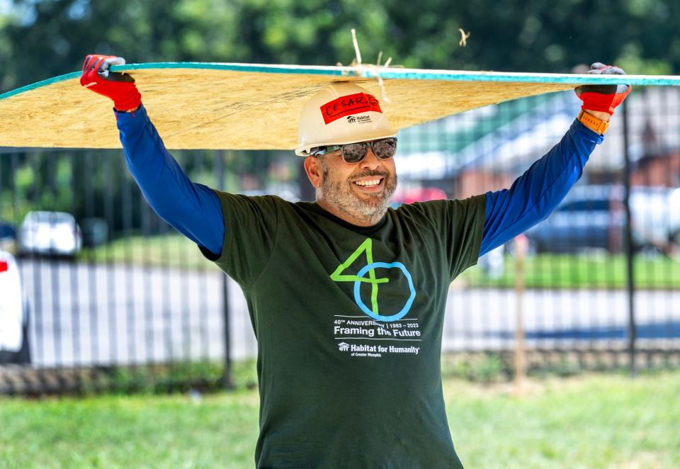 Cesár González, Memphis Habitat repairs project manager, carried plywood wall panels to install on new Habitat homes in Castalia Heights on Aug. 17. Memphis Habitat will complete 12 homes and simultaneously create 12 no-interest mortgages there this fall.