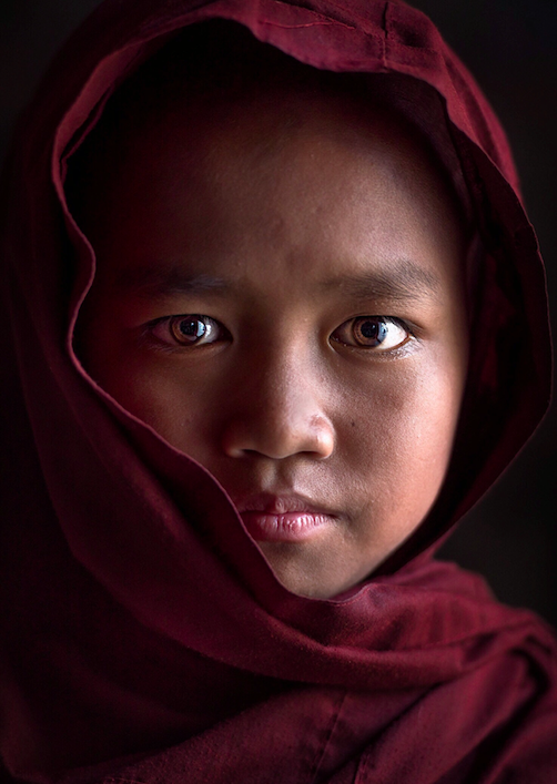 The photographer took a picture of this young novice, who was sent to the monastery by his parents when he was only six years old. He will be studying there until his parents come back for him.