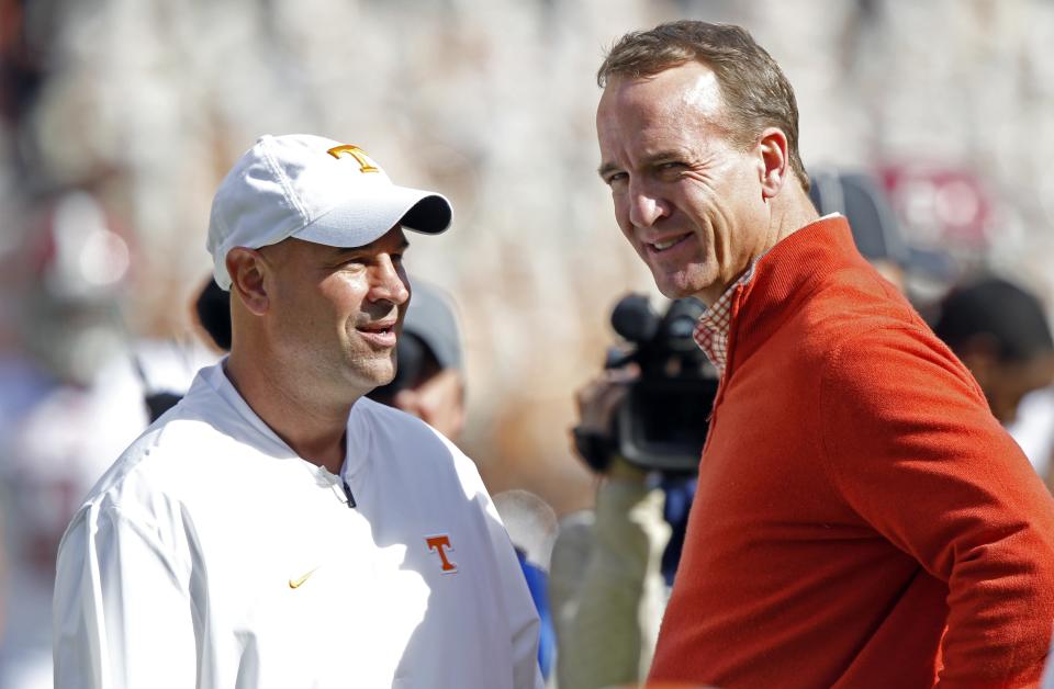 Tennessee head coach Jeremy Pruitt talks with former Tennessee quarterback Peyton Manning before an NCAA college football game against Alabama, Saturday, Oct. 20, 2018, in Knoxville, Tenn. (AP Photo/Wade Payne)