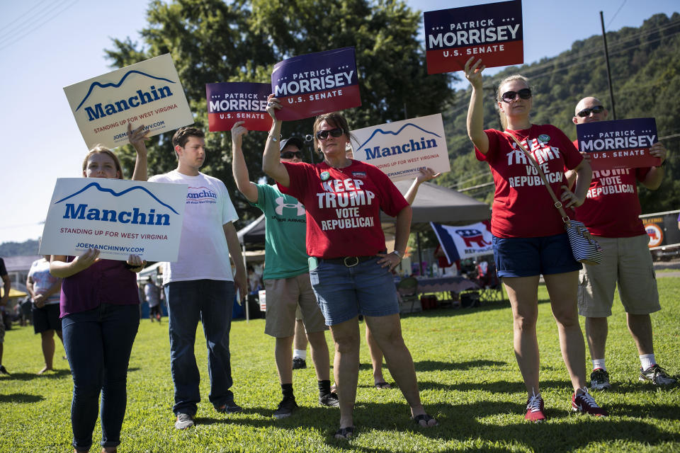 Demonstrators campaign on Sept. 3 in Marmet, W.Va., in a Senate race that has centered on health care