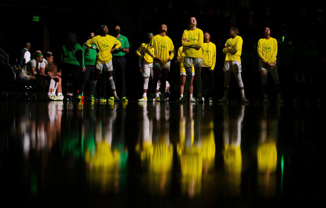 Oregon basketball players watch a highlight video on the overhead screen before their game against Arizona State Feb. 1, 2022.