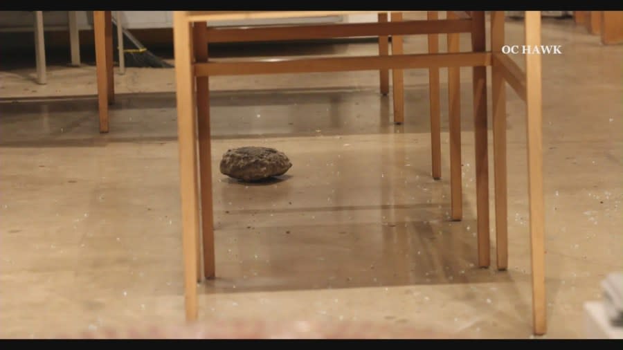 A large rock used by a burglar to break into a small business sits on the floor of the store. (OC Hawk)