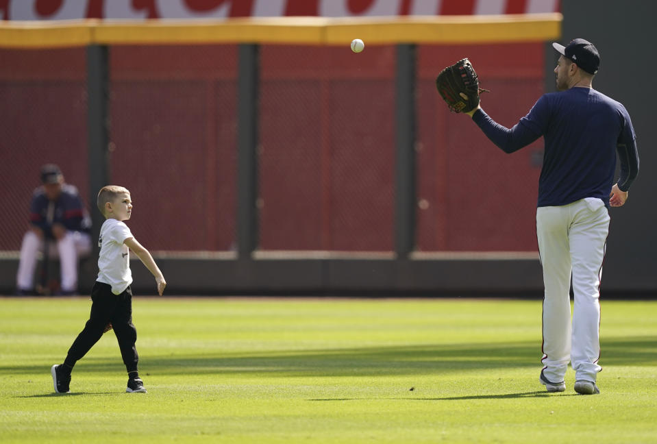 Atlanta Braves' Freddie Freeman works out with his son, Charlie, ahead of the NLCS playoff baseball game, Thursday, Oct. 14, 2021, in Atlanta. (AP Photo/Brynn Anderson)