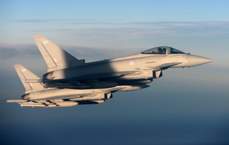 FILE PHOTO: British Royal Air Force's Typhoon Eurofighter jets demonstrate the interception of a Belgian air force transport plane as they fly over Britain