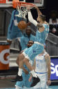 Charlotte Hornets forward Caleb Martin, center, throws down a two-handed dunk against the Los Angeles Lakers during the first half of an NBA basketball game in Charlotte, N.C., Tuesday, April 13, 2021. (Jeff Siner/The Charlotte Observer via AP)