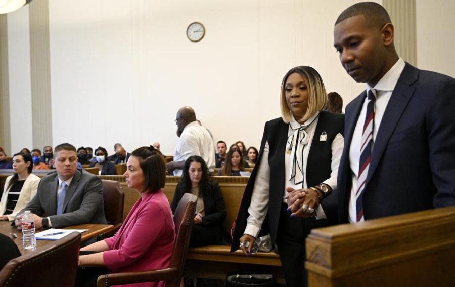 Assistant prosecuting attorney Dion Sankar, right, leads Laurie Bey, mother of Cameron Lamb, to the witness stand to give a statement during the sentencing hearing of former Kansas City police detective Eric DeValkenaere, Friday, March 4, 2022, in Kansas City, Missouri. (Jill Toyoshiba/The Kansas City Star via AP)