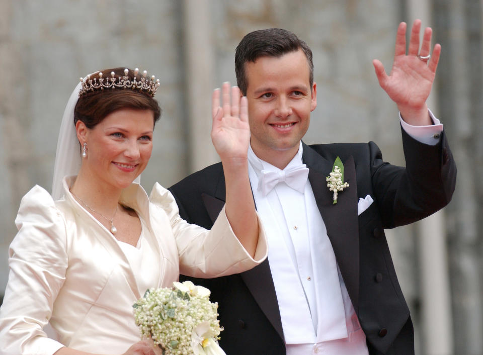 A photo of Princess Martha Louise Of Norway and Ari Behn waving to the crowds on on their wedding day on May 24, 2016 in Trondheim