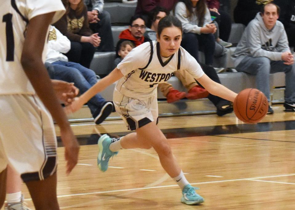 Westport's  Julia George drives to the middle of the court.