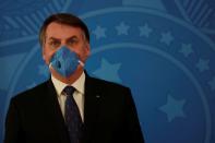 Brazil's President Jair Bolsonaro wears a protective mask during a news conference, amid coronavirus disease (COVID-19) outbreak, in Brasilia