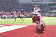 Wisconsin running back Isaac Guerendo (20) scores a touchdown under coverage by Illinois linebacker Calvin Hart Jr. (5) during the first half of an NCAA college football game Saturday, Oct. 1, 2022, in Madison, Wis. (AP Photo/Kayla Wolf)