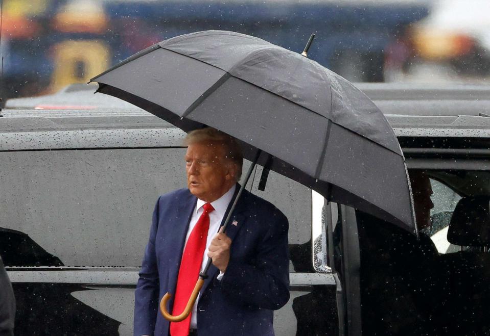 PHOTO: Former U.S. President Donald Trump holds an umbrella as he arrives at Reagan National Airport following an arraignment in a Washington court, Aug. 3, 2023 in Arlington, Va. (Tasos Katopodis/Getty Images)
