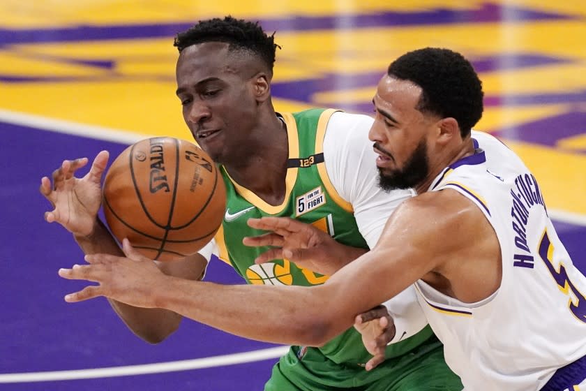 Utah Jazz guard Miye Oni, left, and Los Angeles Lakers guard Talen Horton-Tucker battle for a loose ball.