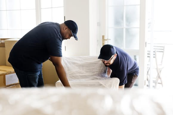 Two men delivering furniture