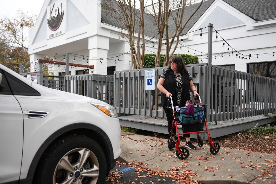 Michelle Weiss leaves Koi Asian Bistro on Pelham Road after lunch on Friday, Nov. 17, 2023. It is one of the few restaurants she attends because it is ADA accessible.  Weiss hopes ACCESS GVL will change that.