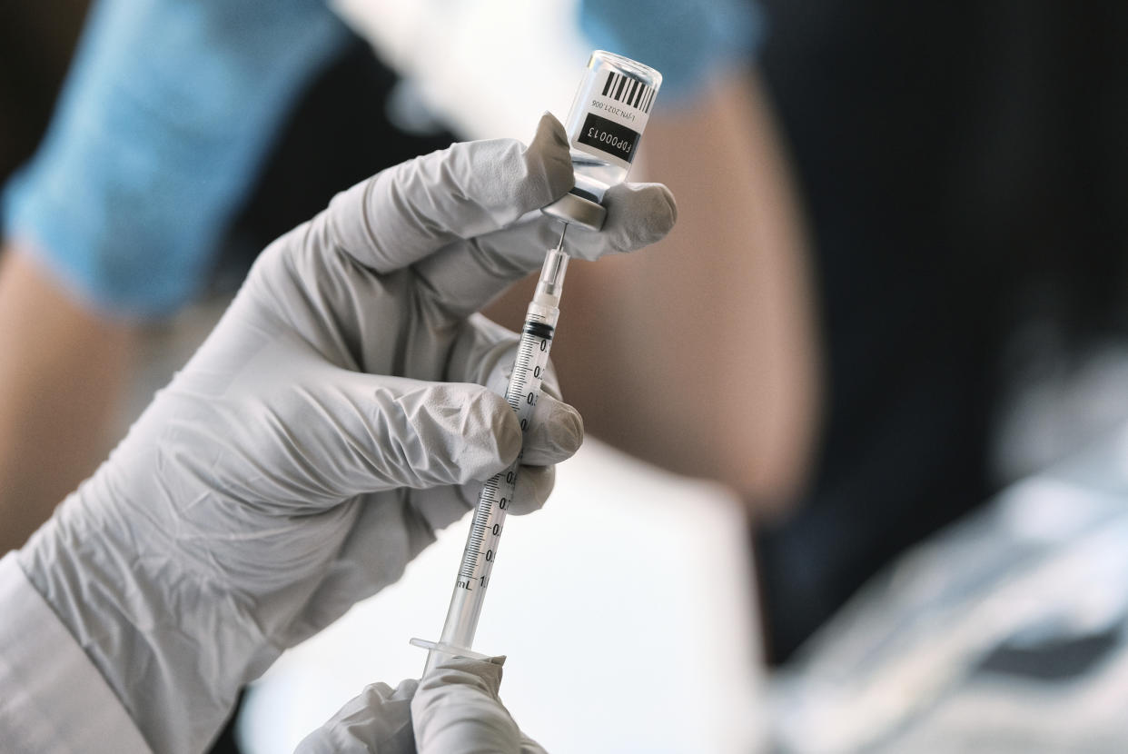 Registered pharmacist Sapana Patel, loads a syringe with Monkeypox vaccine at a Pop-Up Monkeypox vaccination site on Wednesday, Aug. 3, 2022, in West Hollywood, Calif. (AP Photo/Richard Vogel)