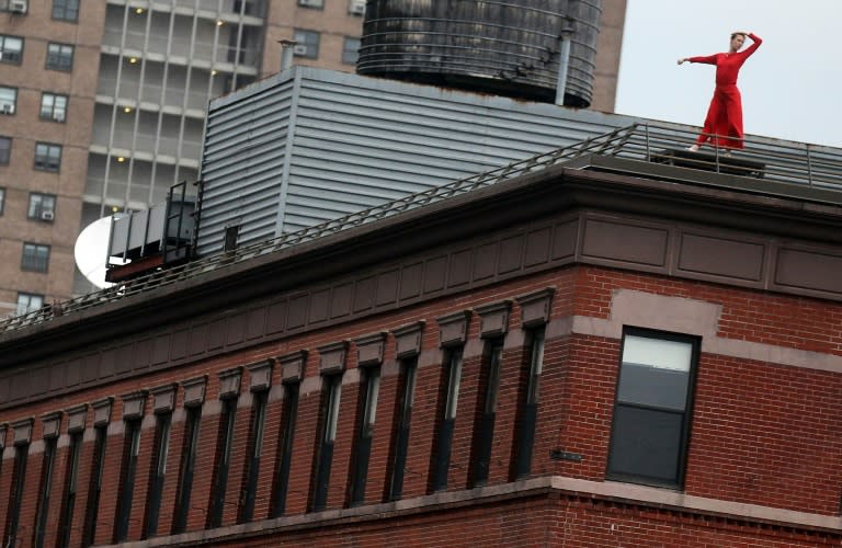 A dancer from the Trisha Brown Dance Company performs 'Roof Piece' above the High Line Park in New York, in 2011