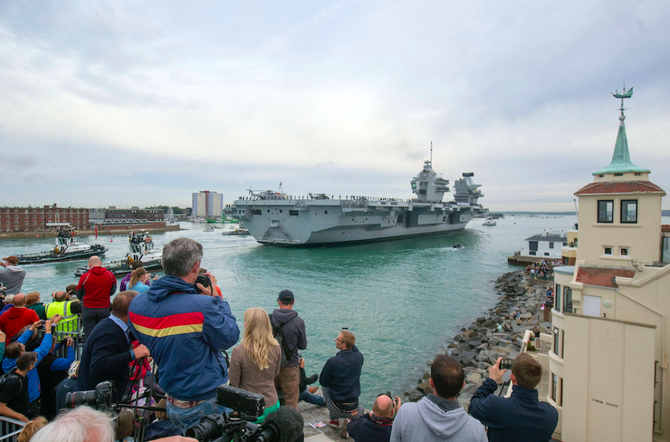 <em>Crowds lined Portsmouth Harbour to watch HMS Queen Elizabeth arrive (PA)</em>