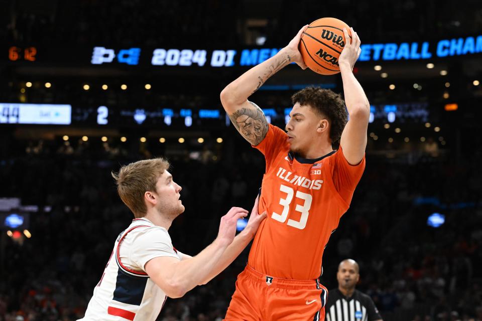 Mar 30, 2024; Boston, MA, USA; Illinois Fighting Illini forward Coleman Hawkins (33) attempts to dribble against the Connecticut Huskies in the finals of the East Regional of the 2024 NCAA Tournament at TD Garden. Mandatory Credit: Brian Fluharty-USA TODAY Sports