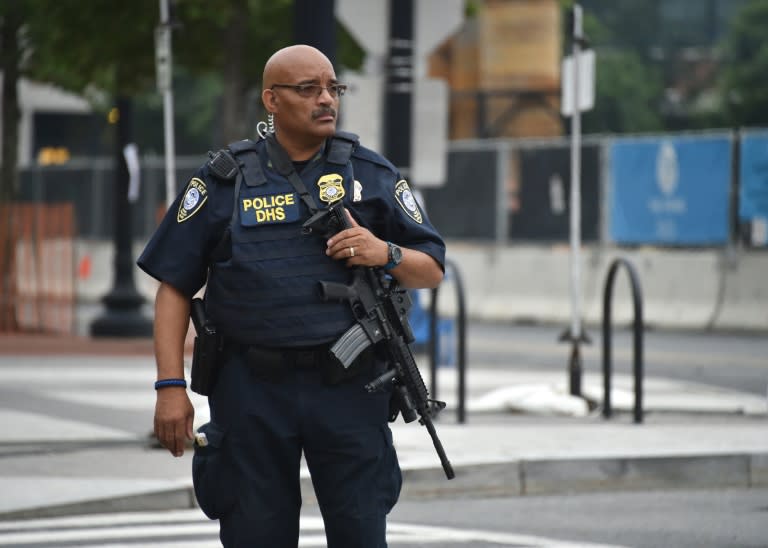 A Department of Homeland Security officer patrols near the scene of an unconfirmed shooting at the Navy Yard in Washington, DC on July 2, 2015. The Navy Yard in Washington was put on lockdown Thursday amid unconfirmed reports of an active gunman on the military facility, the scene of a deadly shooting two years ago, the US Navy said. A Navy officer who was inside the complex told CNN people scrambled for cover after hearing someone shout to get out of the building and stay away from the cafeteria. But Lieutenant Commander Scott Williams said he heard no shots or saw any signs of a struggle. "We heard someone scream, get out of the building, stay away from the cafeteria and we saw everyone running for the exits or adjoining offices," he said. AFP PHOTO/ MLADEN ANTONOV