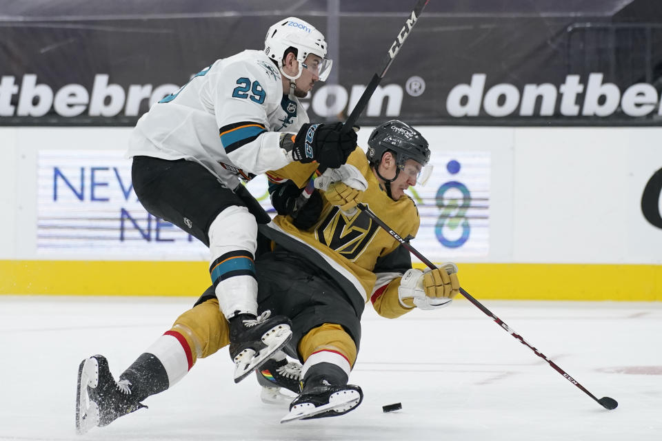 San Jose Sharks right wing Kurtis Gabriel (29) knocks Vegas Golden Knights left wing Tomas Nosek (92) to the ice during the third period of an NHL hockey game Wednesday, March 17, 2021, in Las Vegas. (AP Photo/John Locher)